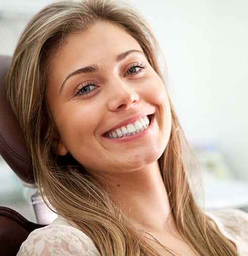 smiling woman sitting in a dental chair