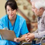 senior dental patient consults with dental assistant about dental savers plan for affordable dental care