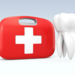 A white tooth floating next to a red and white first aid kit to represent a dental emergency