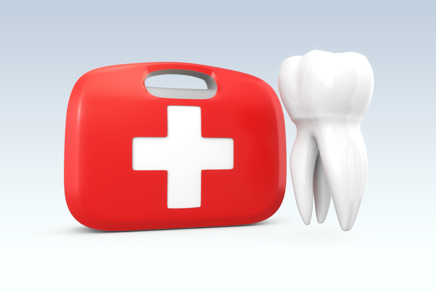 A white tooth floating next to a red and white first aid kit to represent a dental emergency