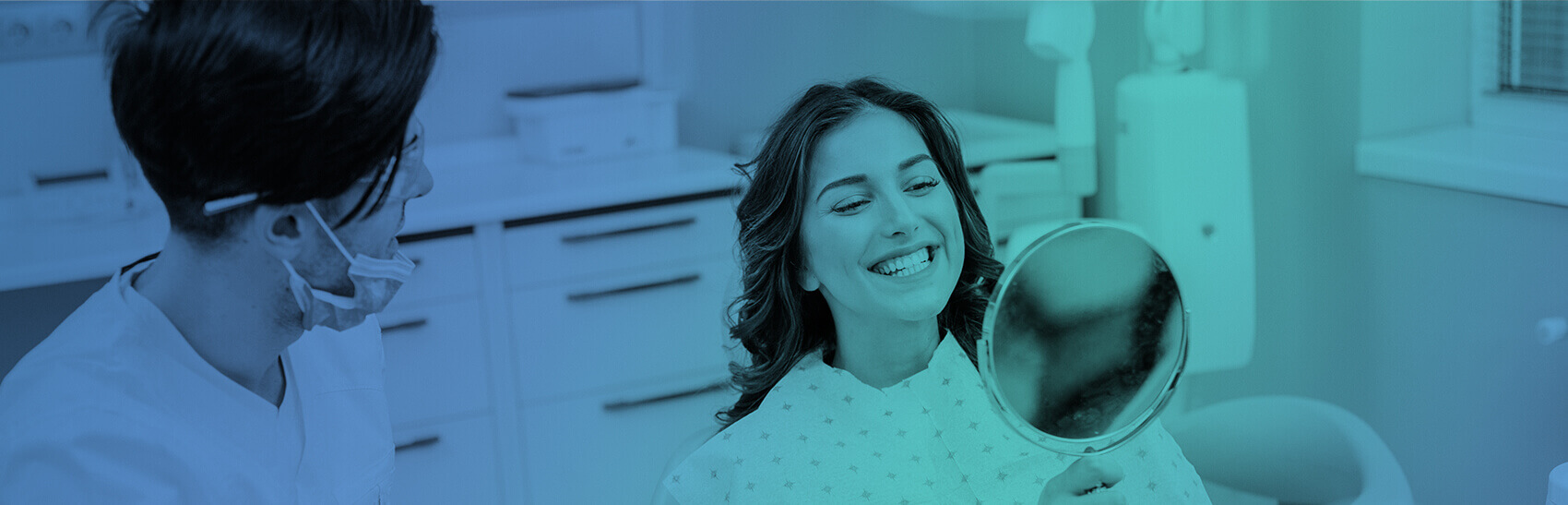 woman smiling into a mirror with her dentist