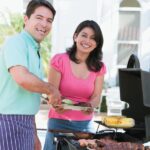 couple dishing up food at the BBQ