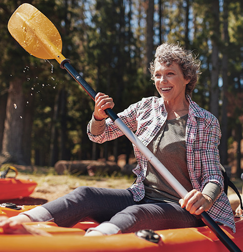 senior woman outside kayaking