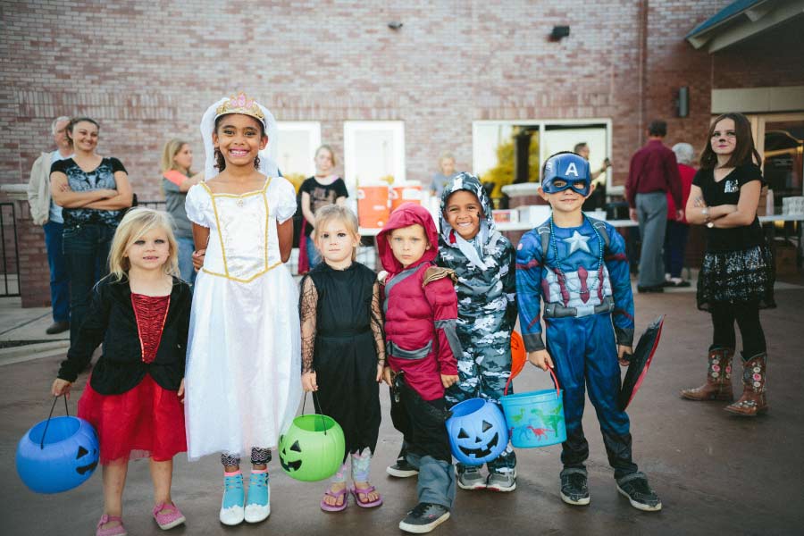 group of kids dressed for Halloween trick or treating