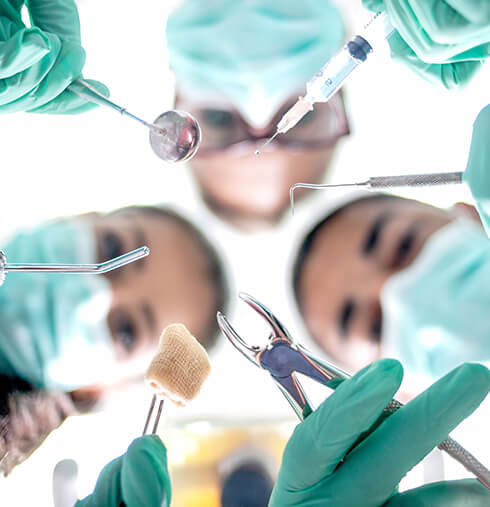 oral surgeons holding tools