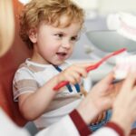 child in dental chair at pediatric dentist