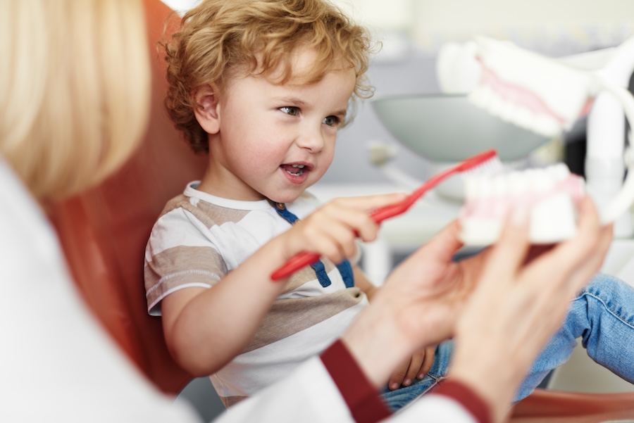 child in dental chair at pediatric dentist